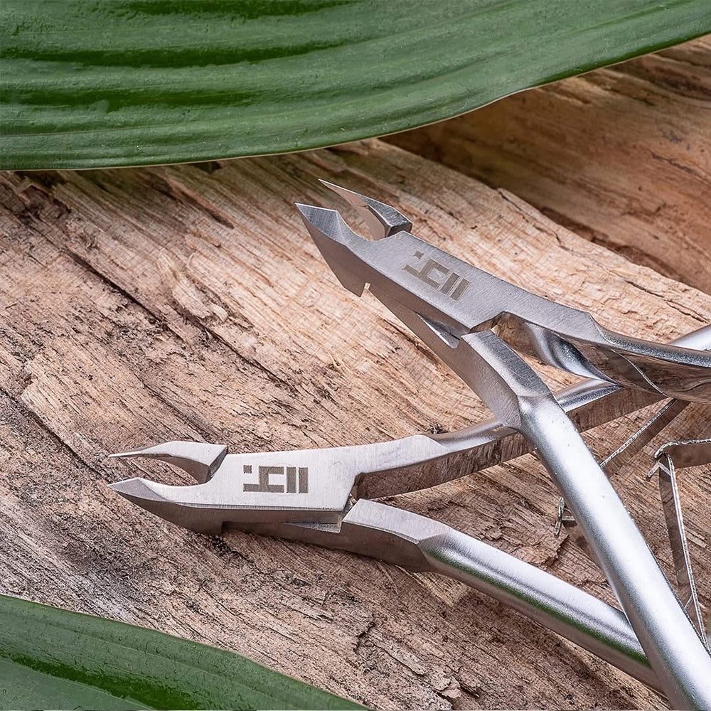 Metal pliers with a brand logo on a wooden surface